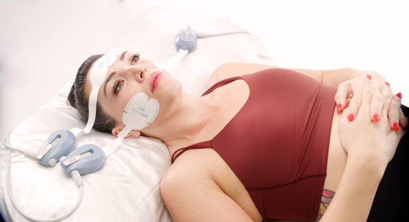 Woman receiving EMFACE treatment